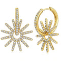 A pair of gold huggie hoop earrings featuring a sunburst design paved with clear cubic zirconia stones, displayed on a clean white background.