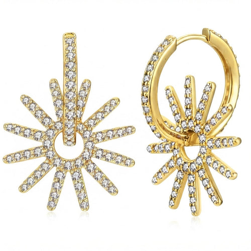 A pair of gold huggie hoop earrings featuring a sunburst design paved with clear cubic zirconia stones, displayed on a clean white background.