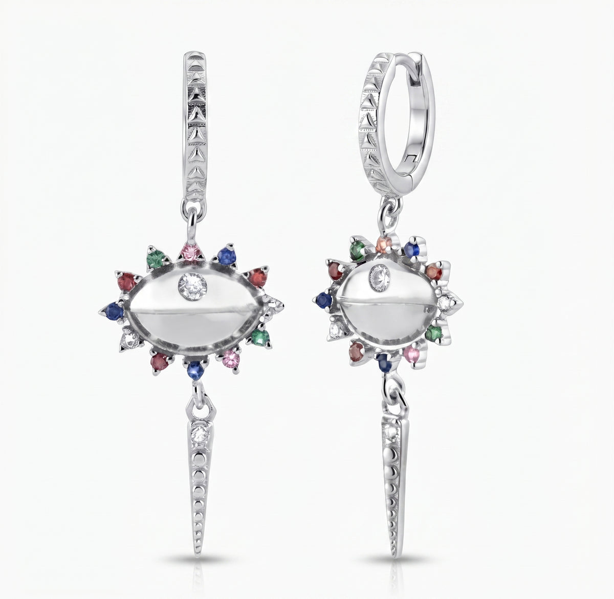 A pair of silver huggie hoop drop earrings featuring an eye-shaped centerpiece with a clear center stone, surrounded by a halo of small multicolored gemstones (red, green, blue, pink, orange) and a dangling spear-shaped charm at the bottom.