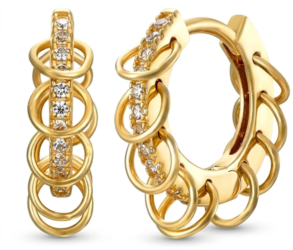 A pair of gold huggie hoop earrings with a multi-layered ring design and a central channel set with clear cubic zirconia stones, shown on a white background.