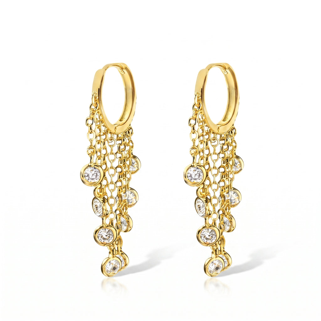 A pair of gold huggie hoop earrings with cascading chain links and clear round gemstones, shown on a clean white background.